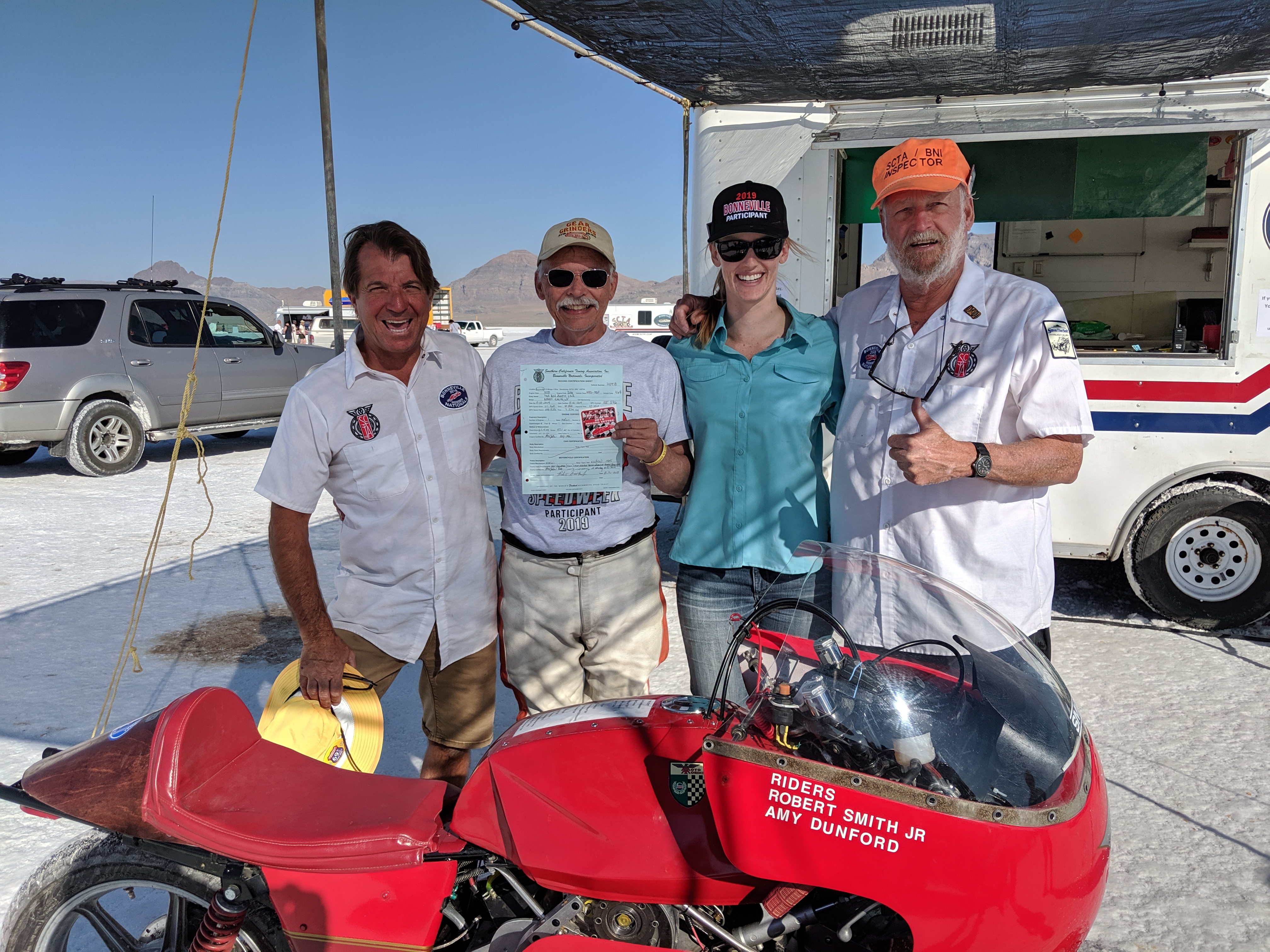 Smitty, Amy, and two technical inspectors at Bonneville standing with The Red Baron