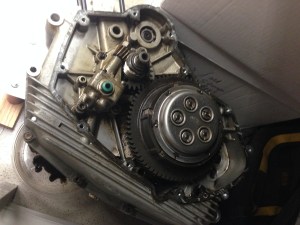 Side view of the engine case with the clutch basket and oil pump